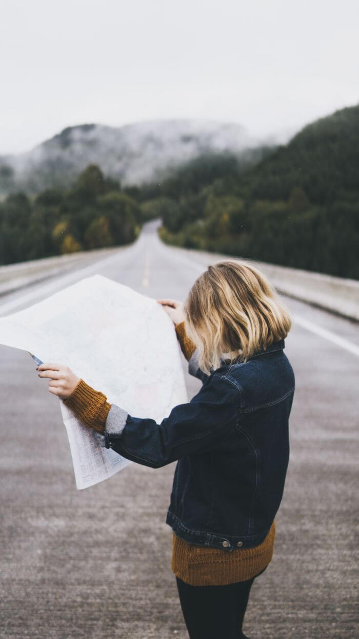 Blonde woman looking at a map