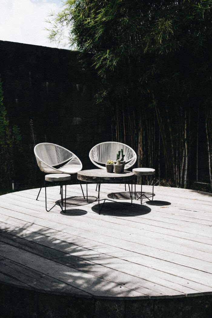gray table with chair near trees