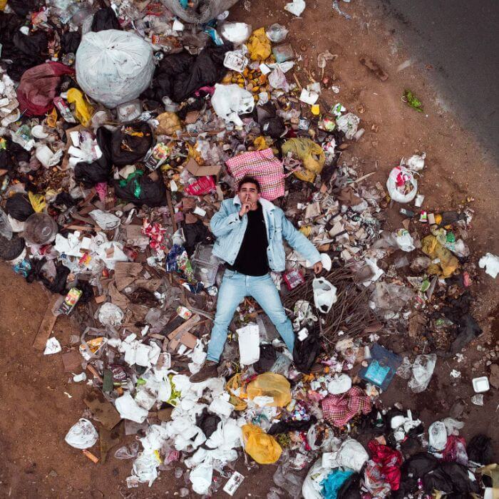 Man lying on the trash